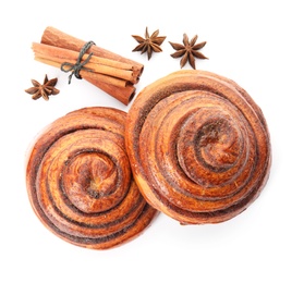 Photo of Freshly baked cinnamon rolls with ingredients on white background, top view