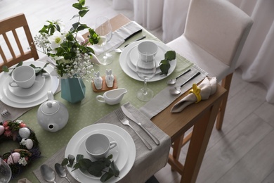 Beautiful Easter table setting with festive decor indoors, above view