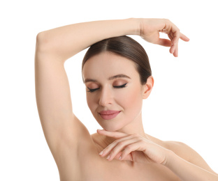 Photo of Young beautiful woman showing armpit with smooth clean skin on white background