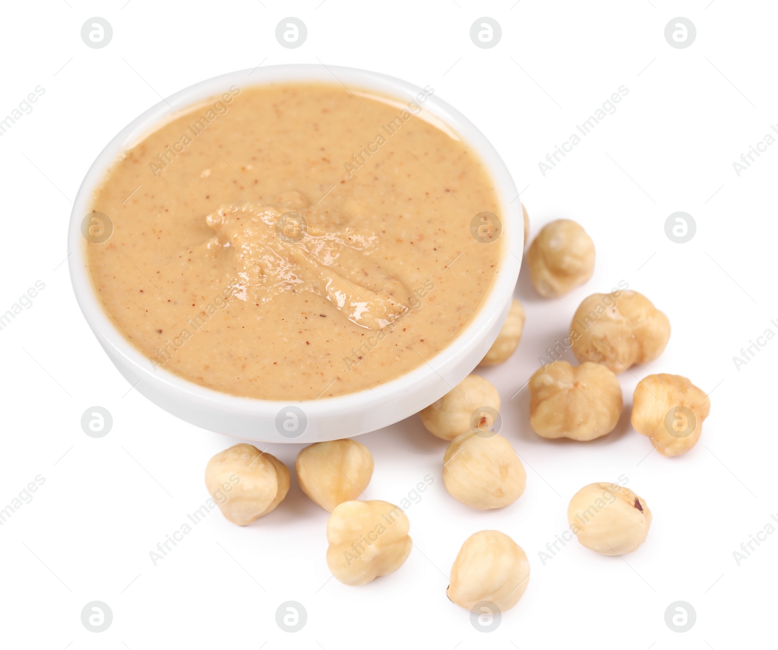 Photo of Delicious nut butter and hazelnuts isolated on white