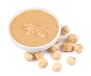 Photo of Delicious nut butter and hazelnuts isolated on white