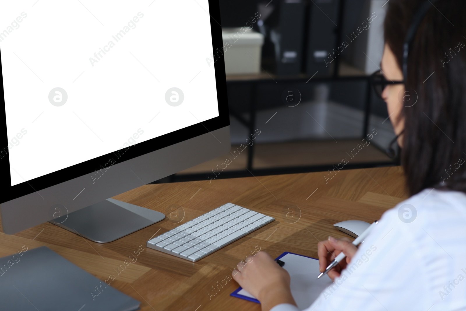 Photo of Doctor working with computer at table in office. Hotline service