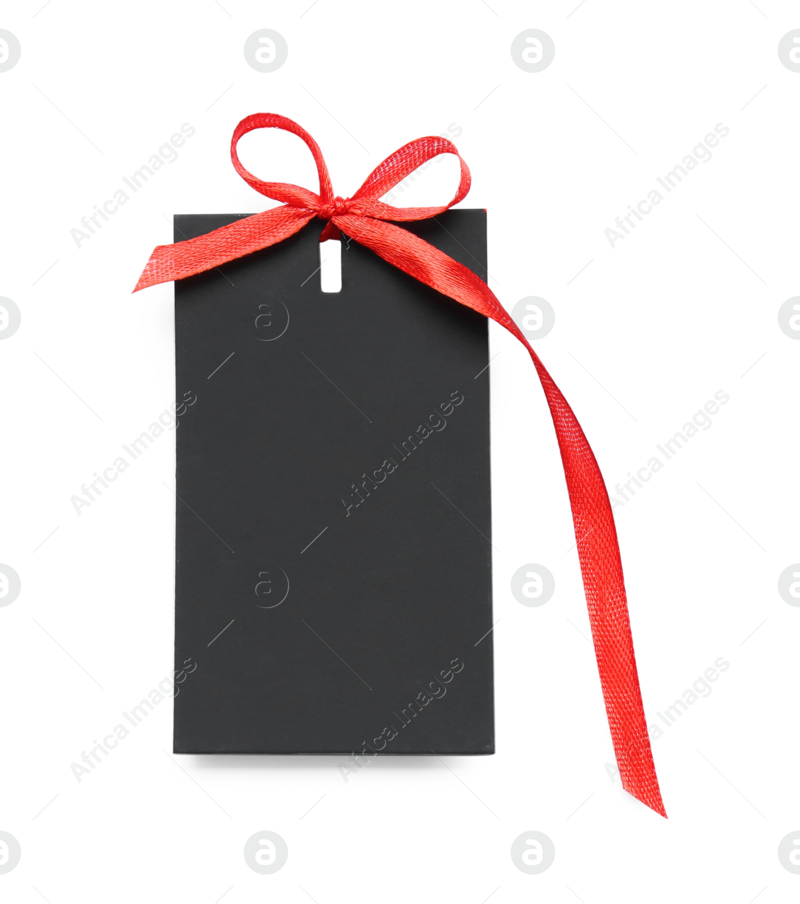 Photo of Blank black gift tag with red satin ribbon on white background, top view. Space for design