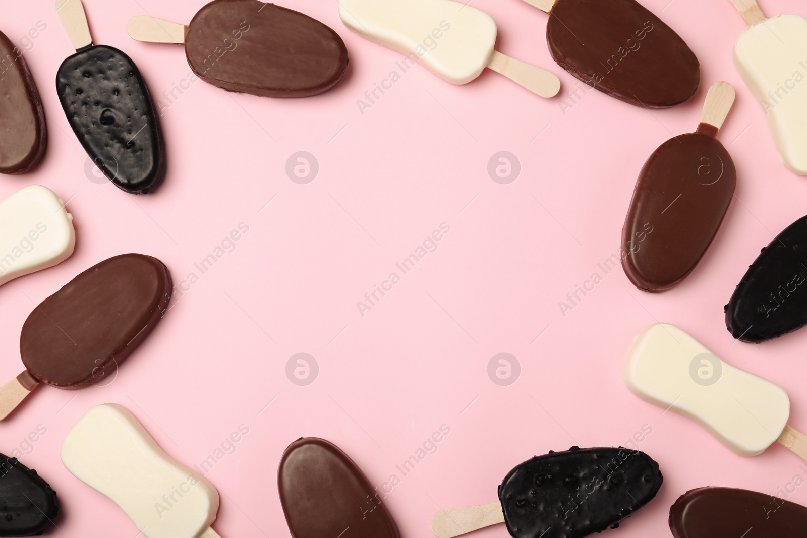 Photo of Frame of different glazed ice cream bars on pink background, flat lay. Space for text