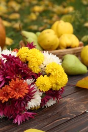 Photo of Composition with beautiful chrysanthemum flowers on wooden board outdoors