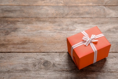 Beautiful gift box on wooden background