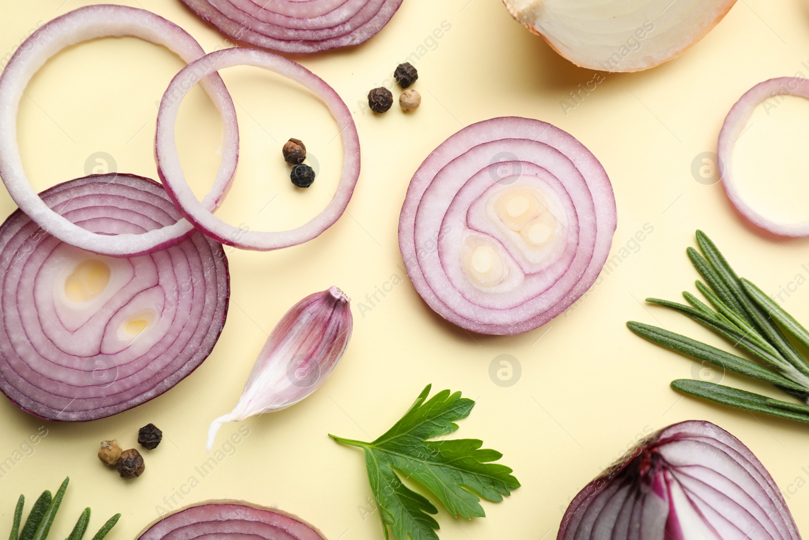 Photo of Flat lay composition with onion and spices on beige background
