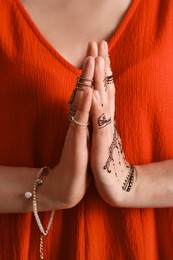 Photo of Woman with henna tattoo on hand, closeup. Traditional mehndi ornament