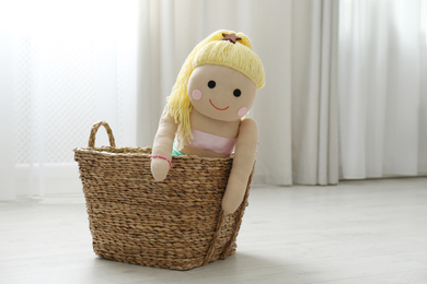Funny doll in basket on floor. Decor for children's room interior