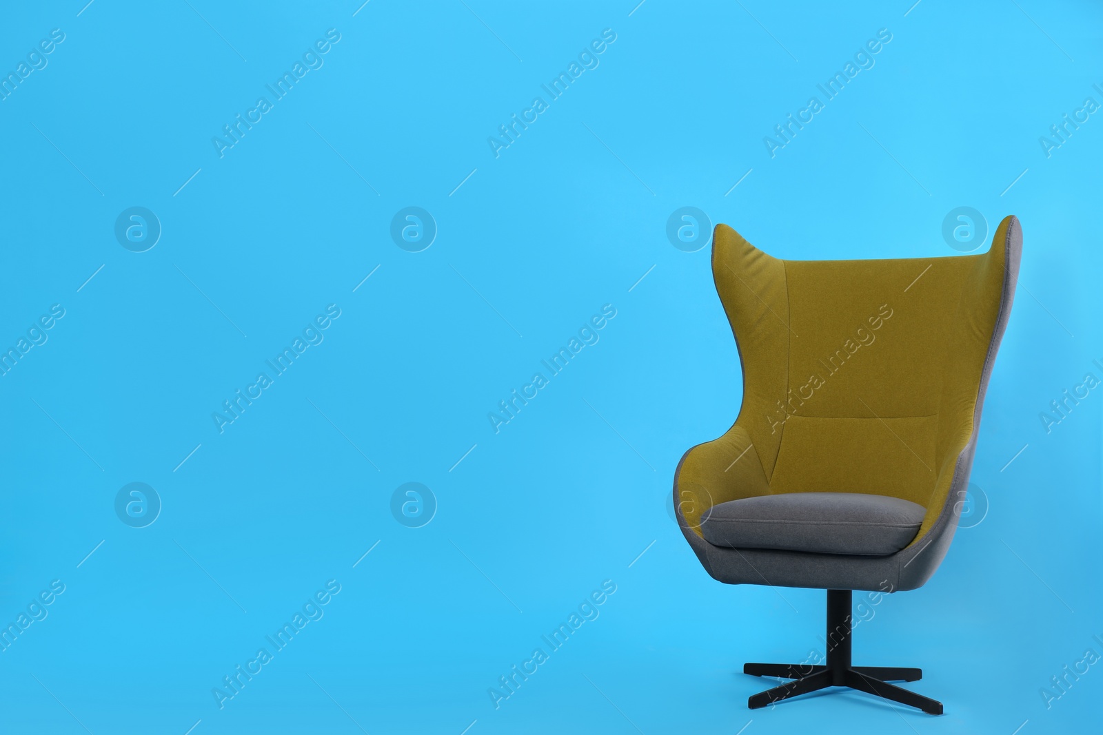 Photo of Comfortable office chair on light blue background, space for text