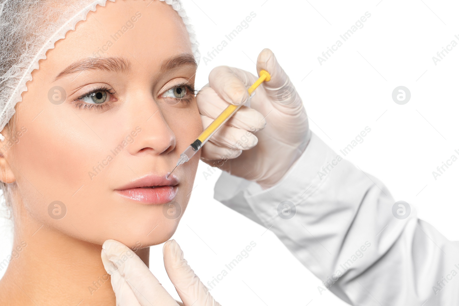 Photo of Young woman getting lips injection on white background. Cosmetic surgery