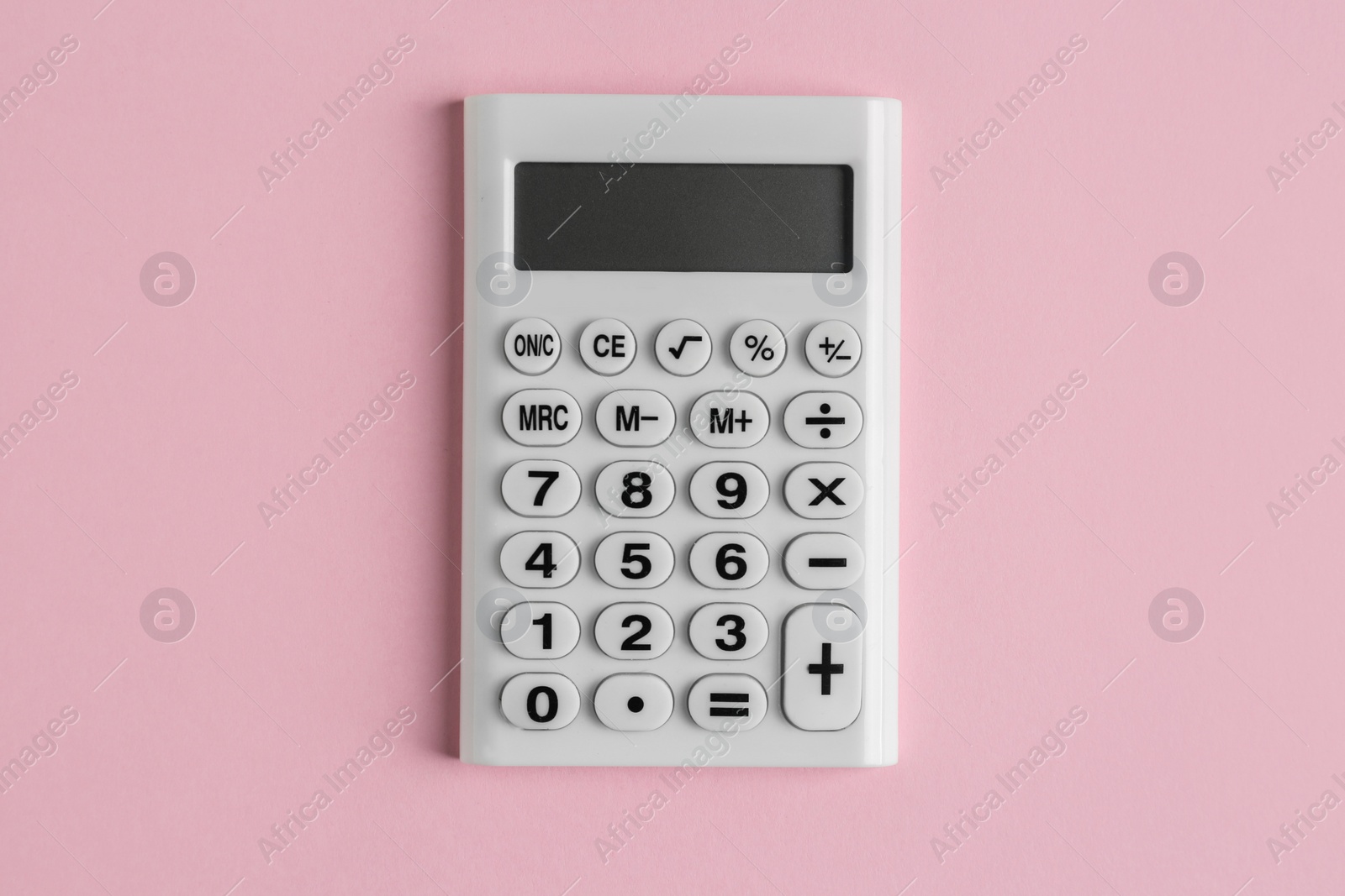 Photo of White calculator on pink background, top view