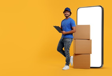 Image of Courier with stack of parcels and clipboard near huge smartphone on orange background. Delivery service. Space for text