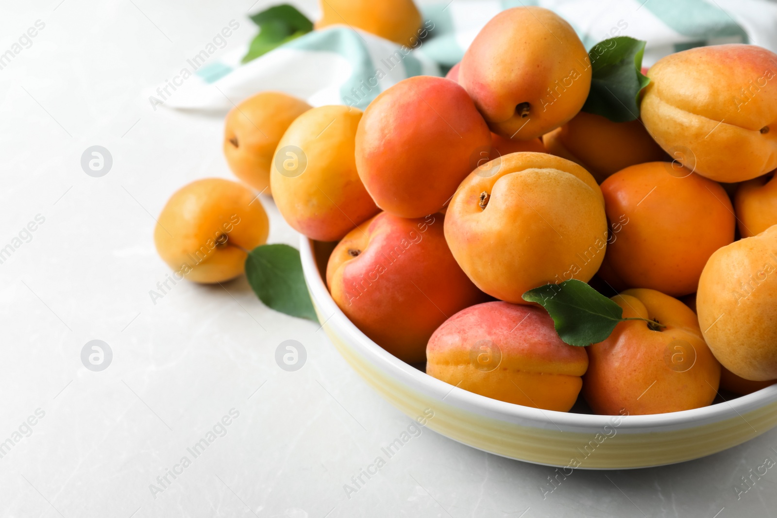 Photo of Delicious fresh ripe apricots on white table, closeup