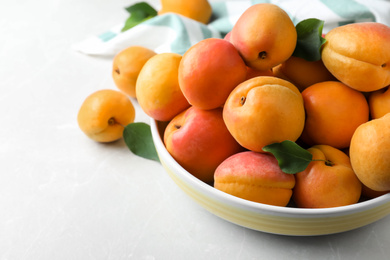 Photo of Delicious fresh ripe apricots on white table, closeup