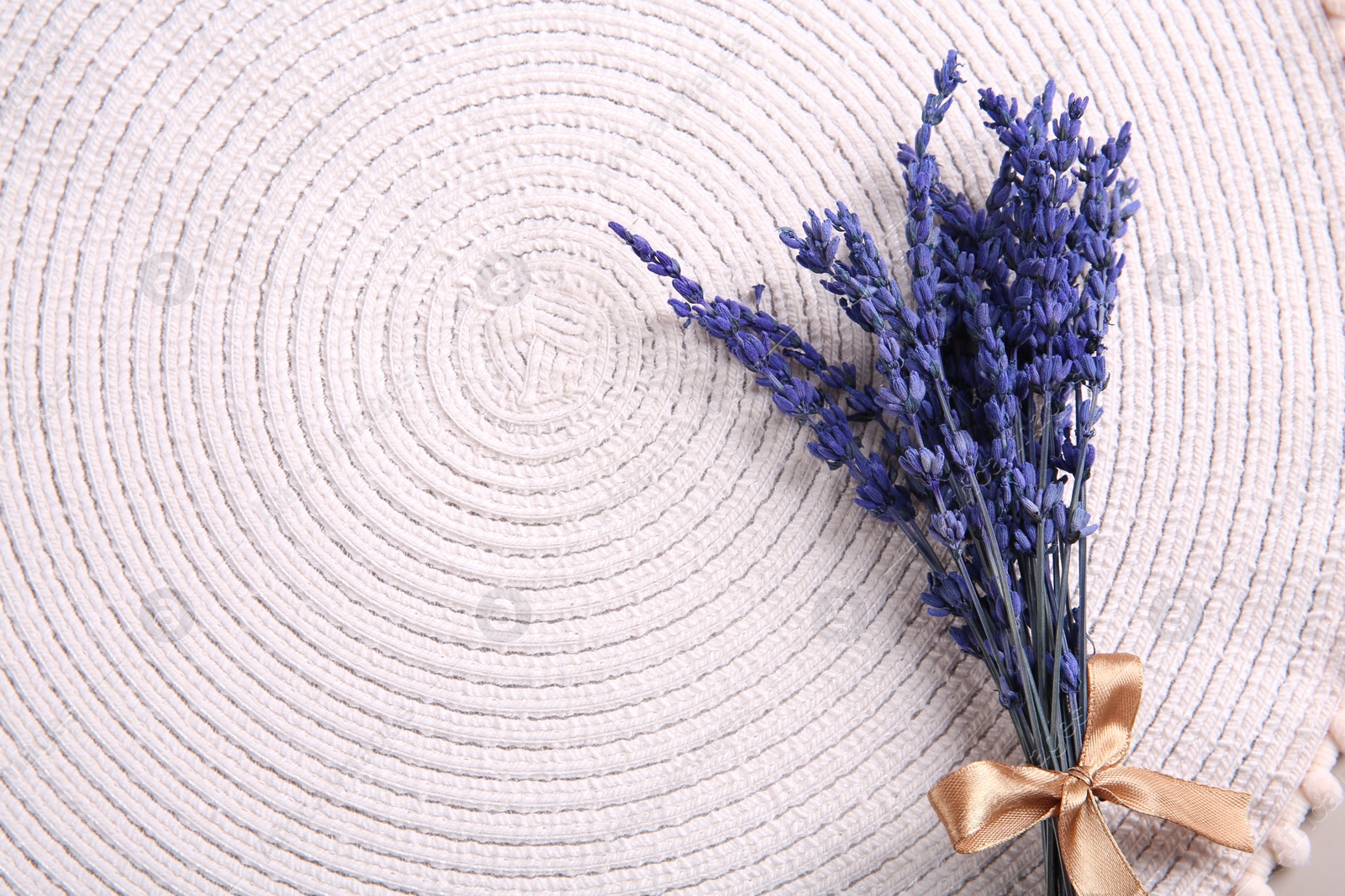 Photo of Bouquet of beautiful preserved lavender flowers on white cotton place mat, top view. Space for text