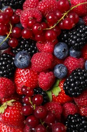 Photo of Different fresh ripe berries as background, top view