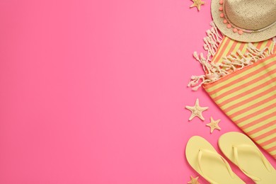 Flat lay composition with different beach objects on pink background, space for text