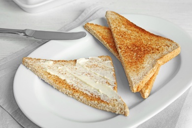 Photo of Plate with tasty bread for breakfast on table