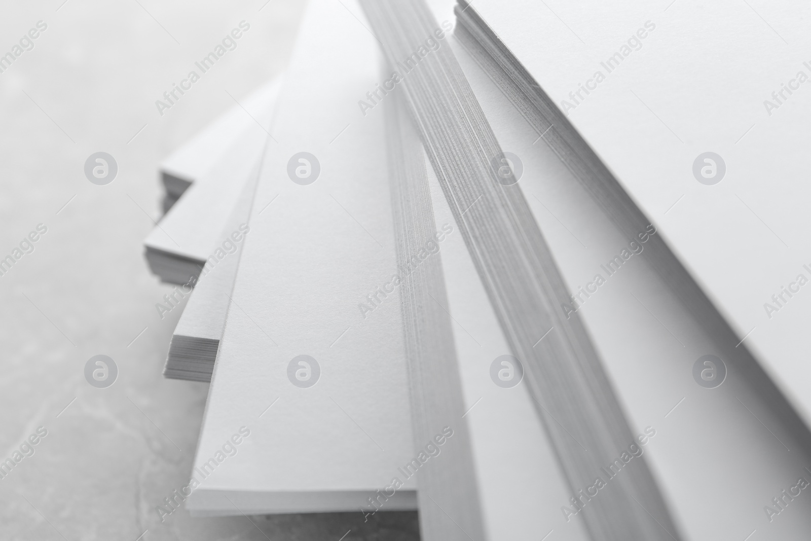 Photo of Stack of blank white paper on marble table, closeup