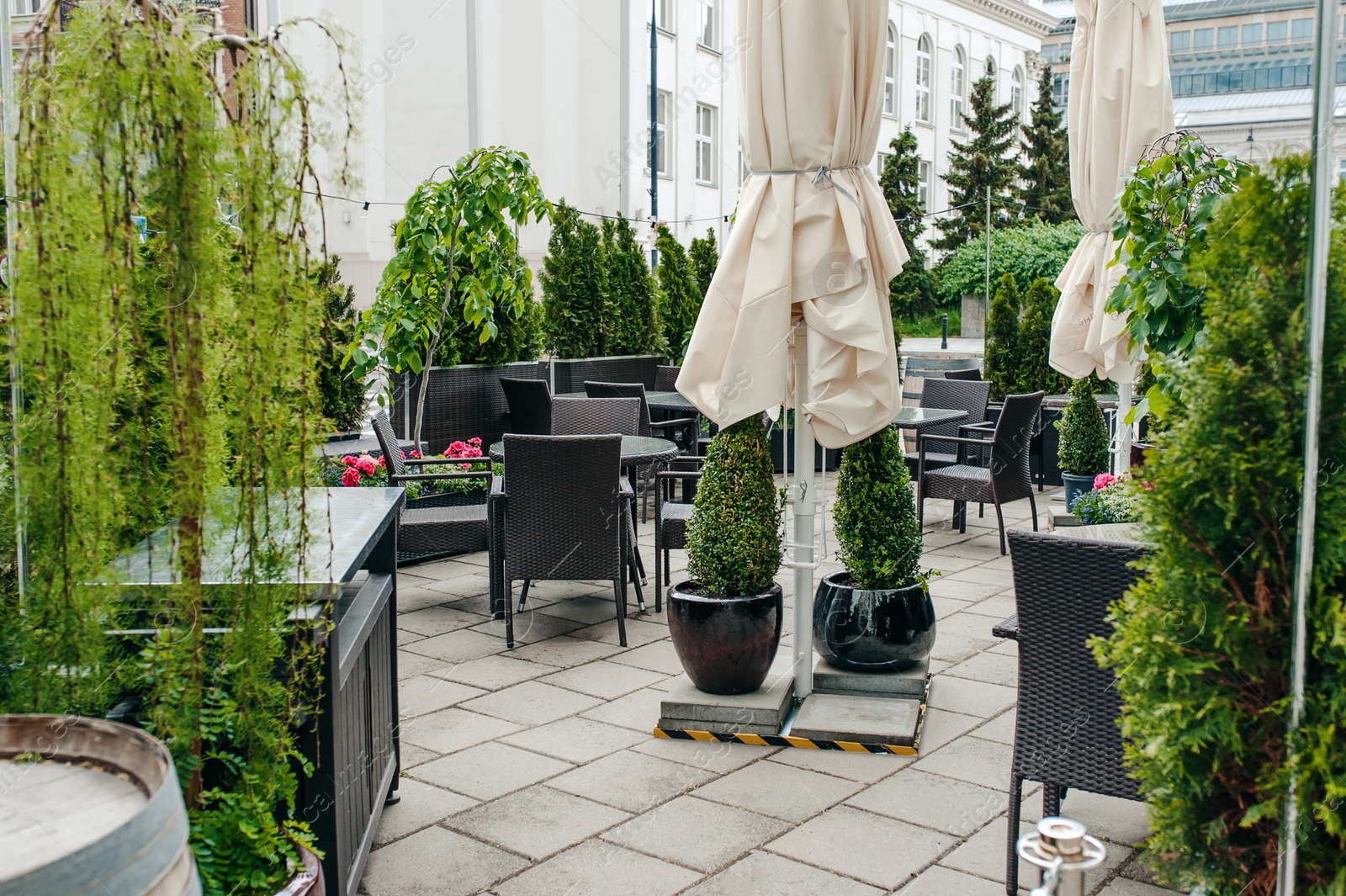 Photo of Many tables and comfortable chairs in outdoor cafe