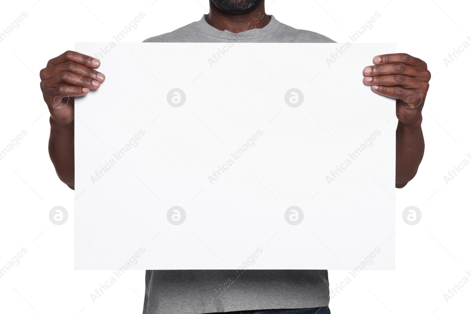 Photo of African American man holding sheet of paper on white background, closeup. Mockup for design