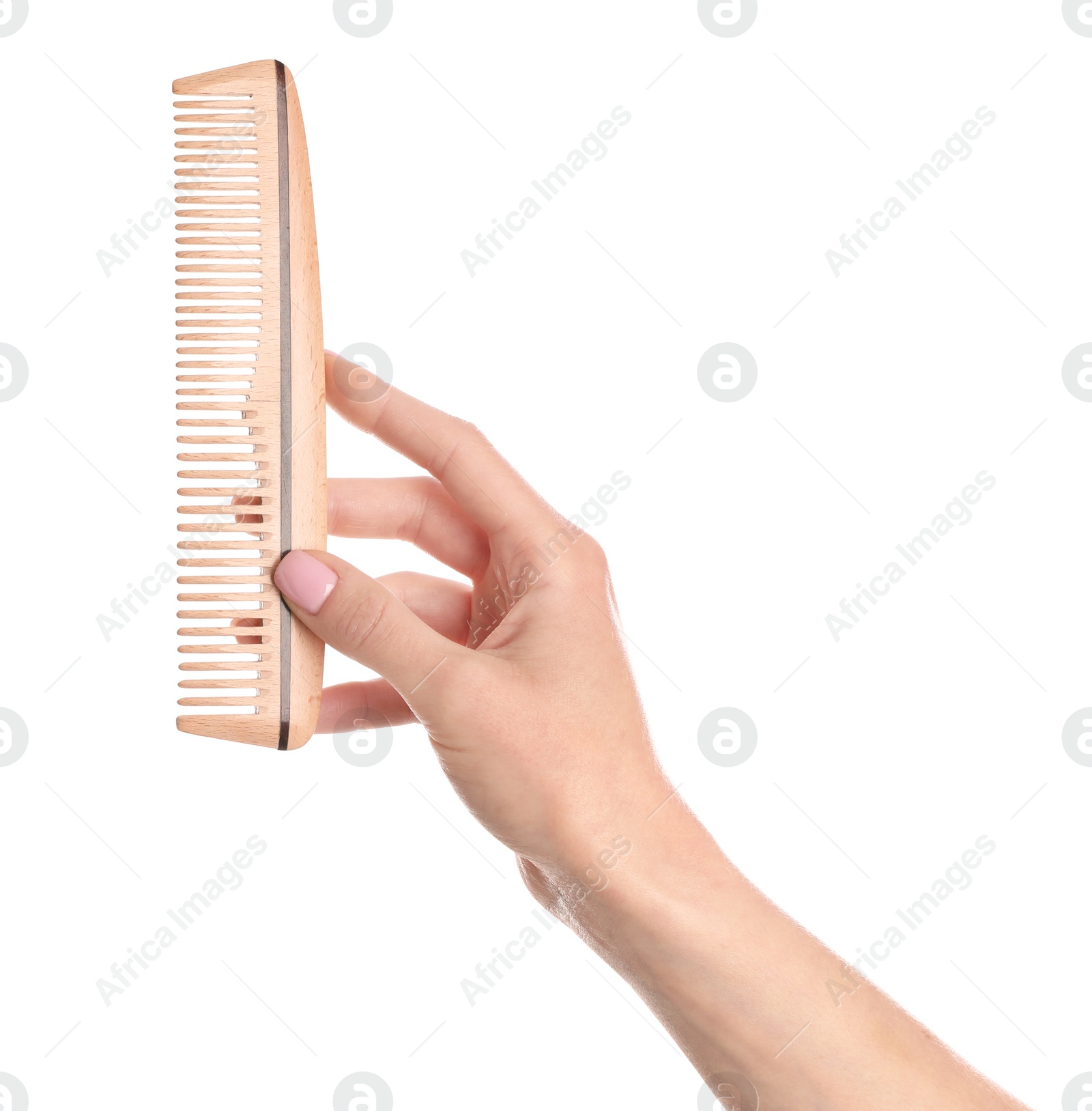 Photo of Woman holding wooden hair comb against white background, closeup