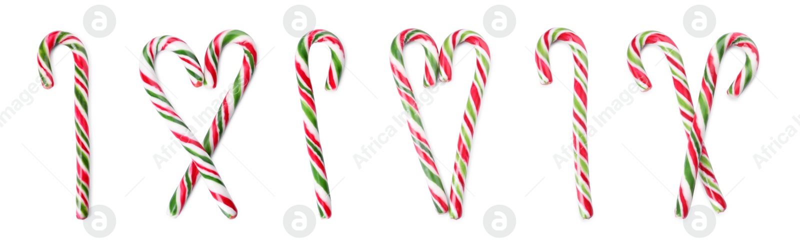 Image of Set with yummy sweet Christmas candy canes on white background, top view. Banner design