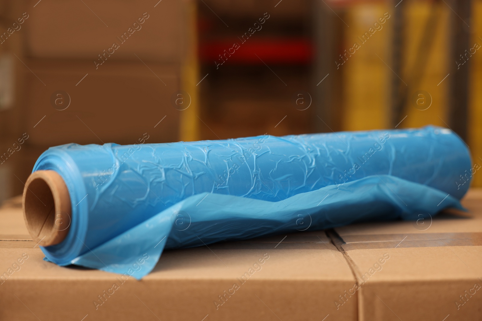 Photo of Roll of stretch wrap on boxes in warehouse