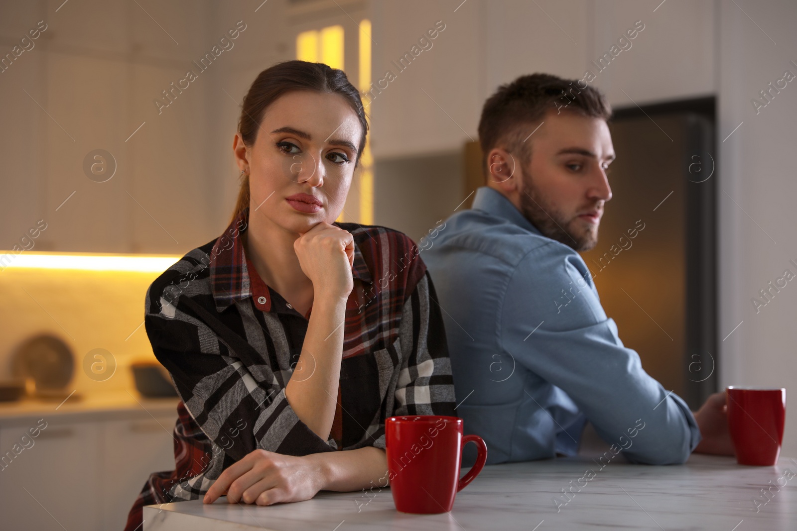 Photo of Young couple quarreling at home. Jealousy in relationship