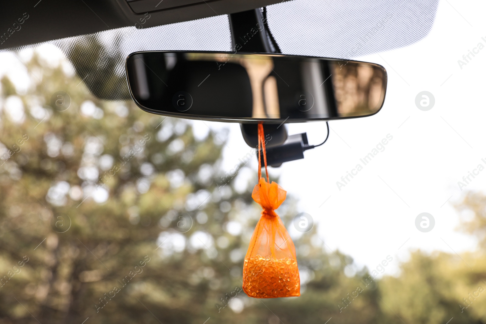 Photo of Air freshener hanging on rear view mirror in car