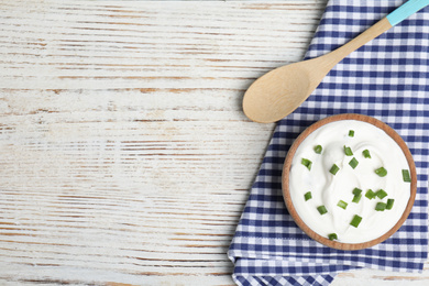 Photo of Fresh sour cream with onion on white wooden table, flat lay. Space for text