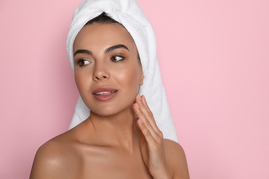 Photo of Beautiful young woman with towel on head against pink background