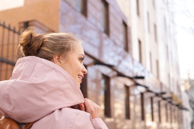 Photo of Young woman with backpack on city street