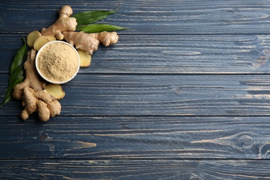 Photo of Dry ginger powder, fresh root and leaves on wooden table, flat lay. Space for text