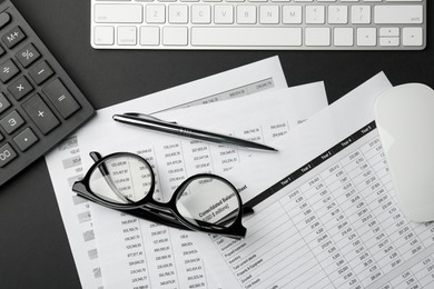 Photo of Flat lay composition with accounting documents and glasses on black table