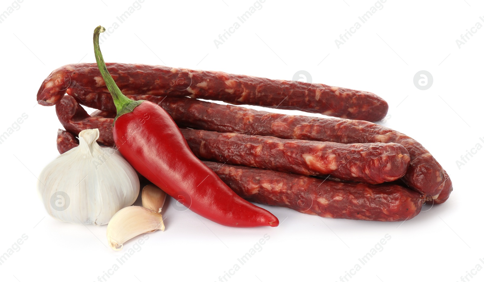 Photo of Thin dry smoked sausages and spices isolated on white
