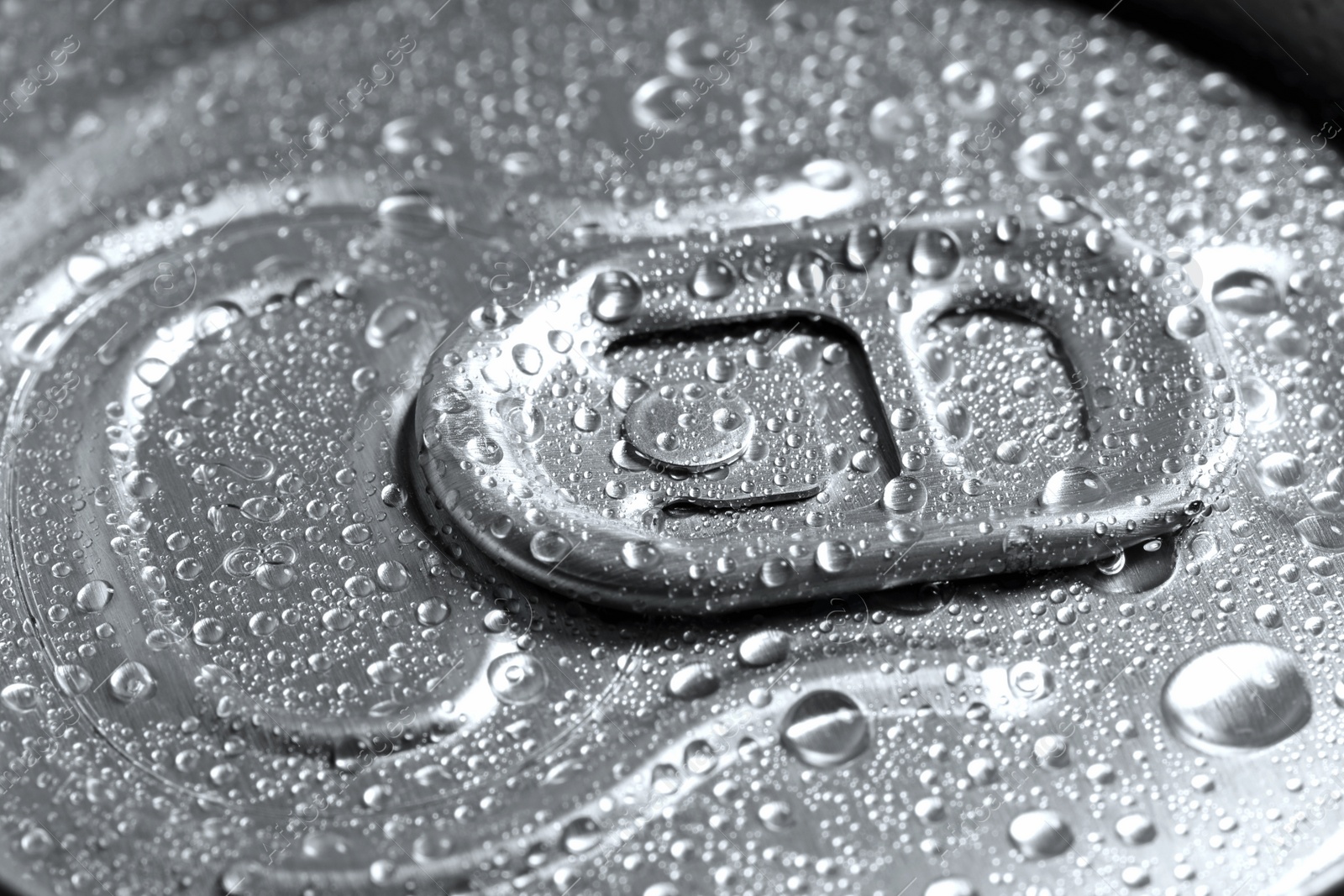 Photo of Aluminum can of beverage covered with water drops as background, closeup