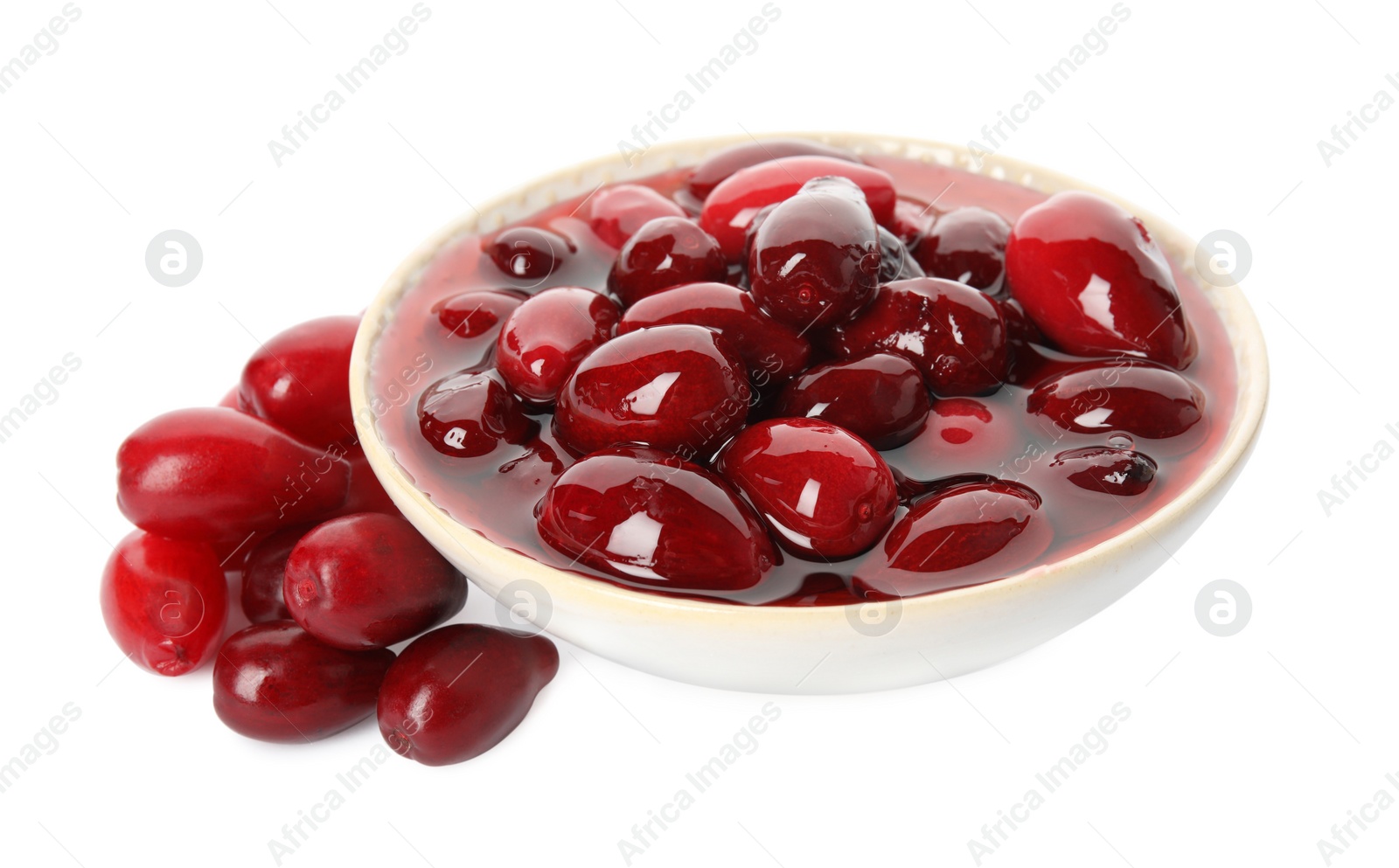 Photo of Delicious dogwood jam with berries on white background