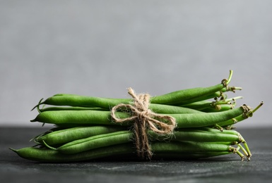 Fresh green beans on black table, closeup