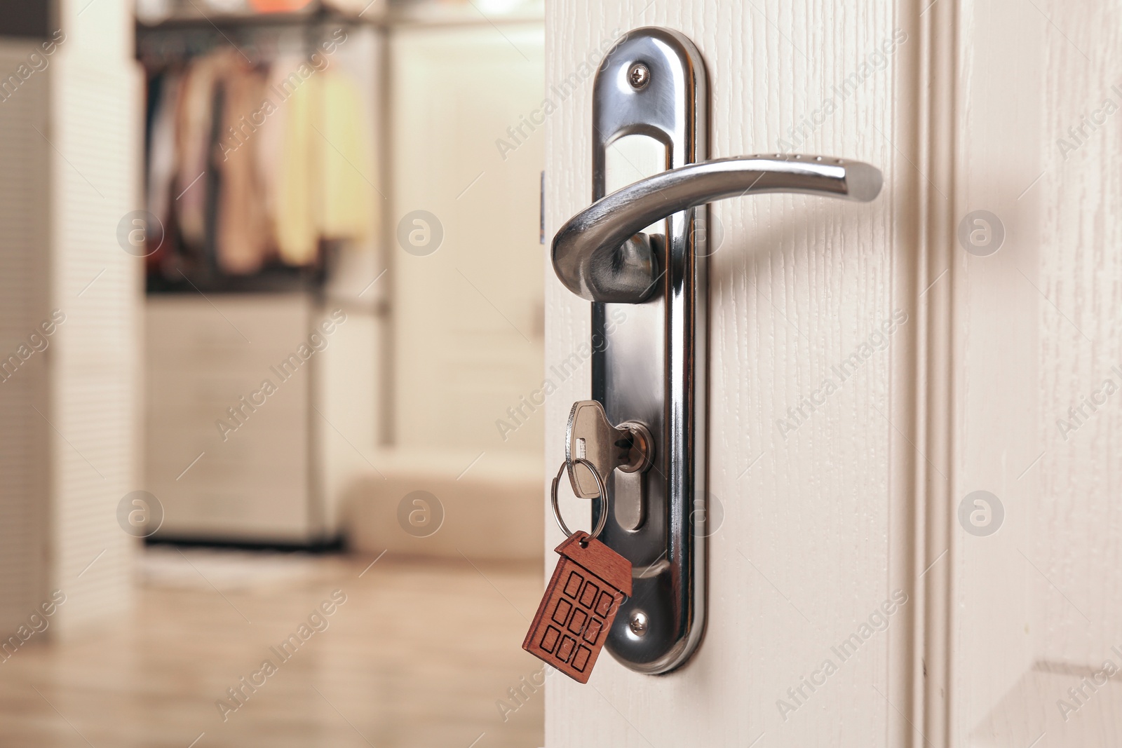 Photo of Closeup view of open door with key in room