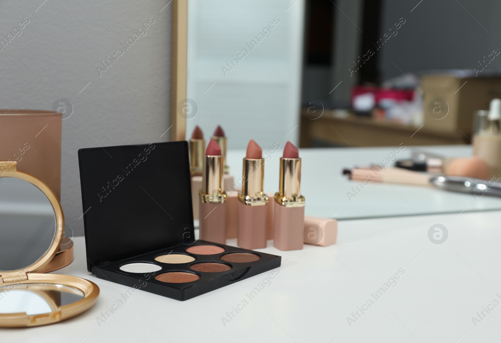 Photo of Stylish dressing table with different cosmetic products and mirror, space for text