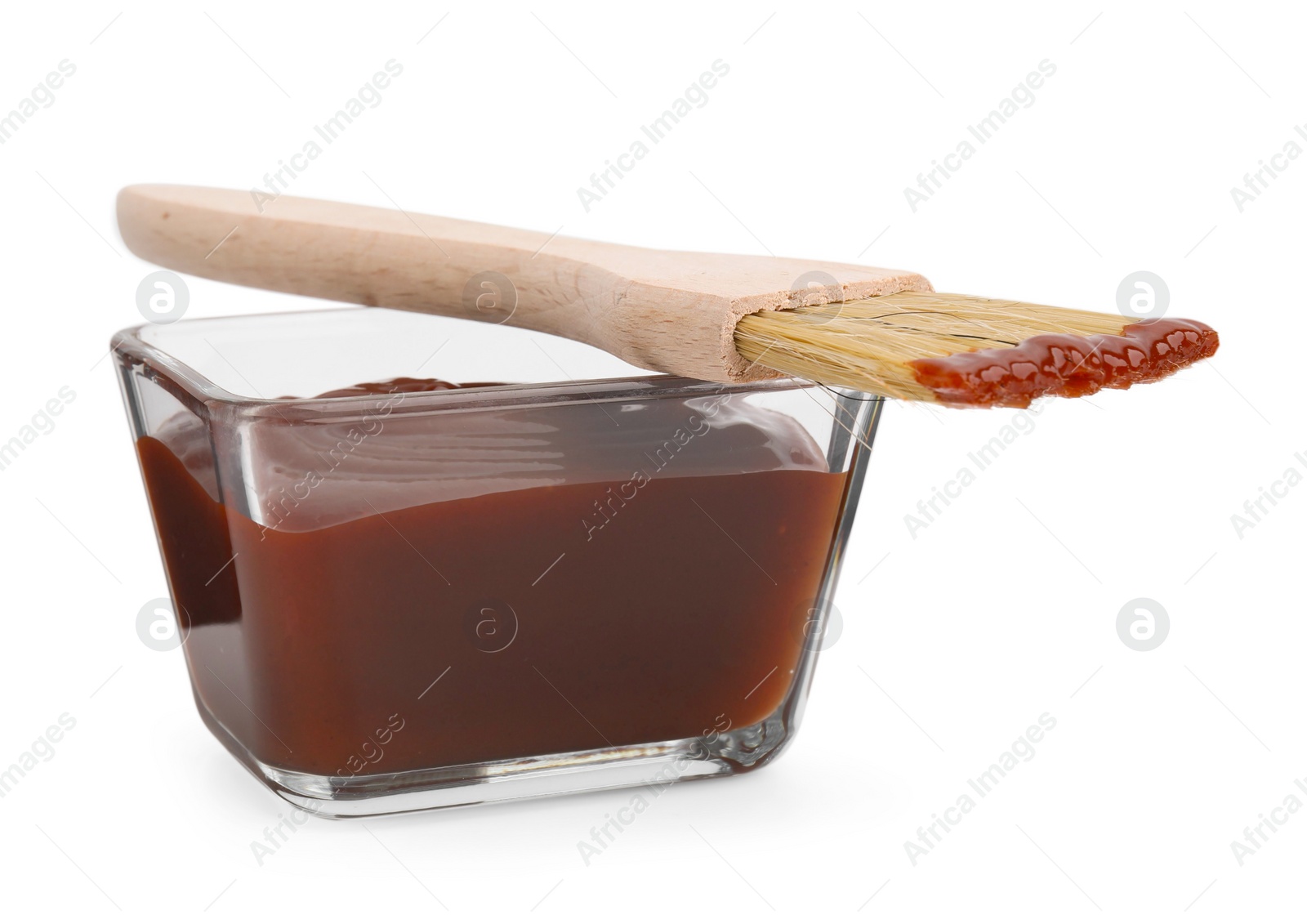 Photo of Marinade in bowl and basting brush isolated on white