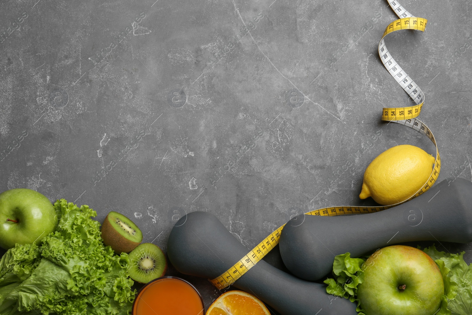 Photo of Flat lay composition with healthy food and space for text on gray background. Concept of weight loss