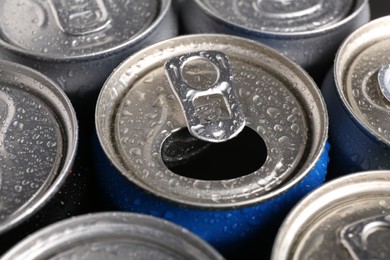 Photo of Energy drinks in wet cans as background, closeup. Functional beverage