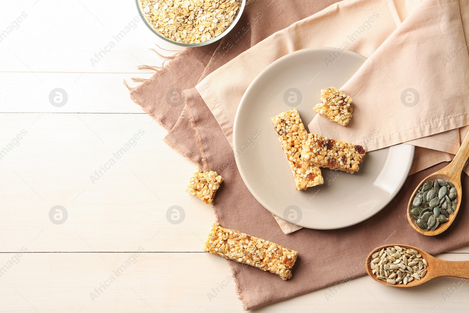 Photo of Flat lay composition with grain cereal bars on table. Healthy snack