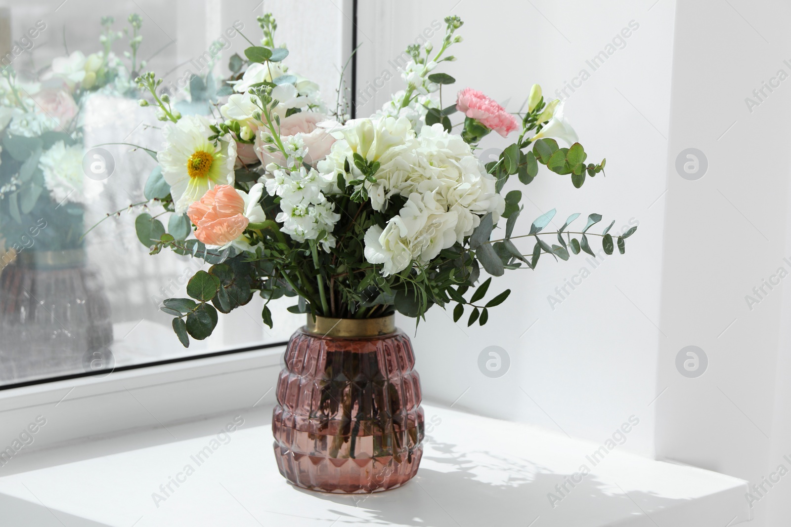 Photo of Bouquet of beautiful flowers on windowsill indoors