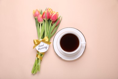 Photo of Cup of coffee, beautiful tulips and card with text Good Morning on beige background, flat lay