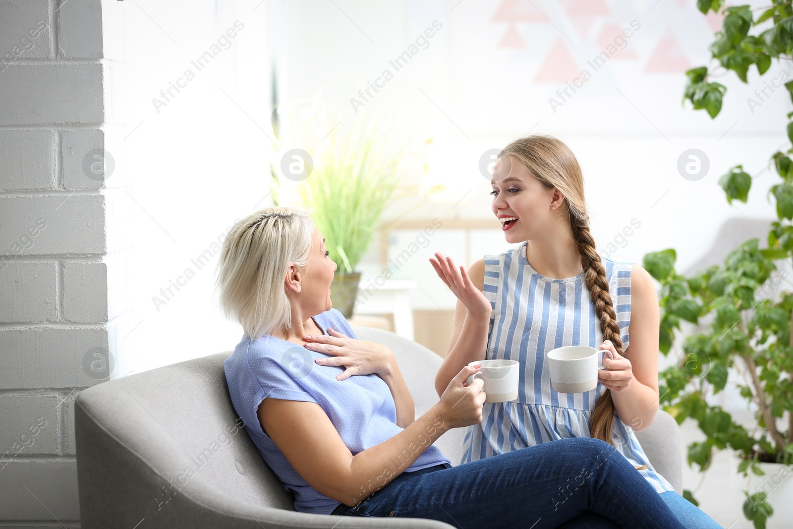 Photo of Mother and her adult daughter spending time together at home