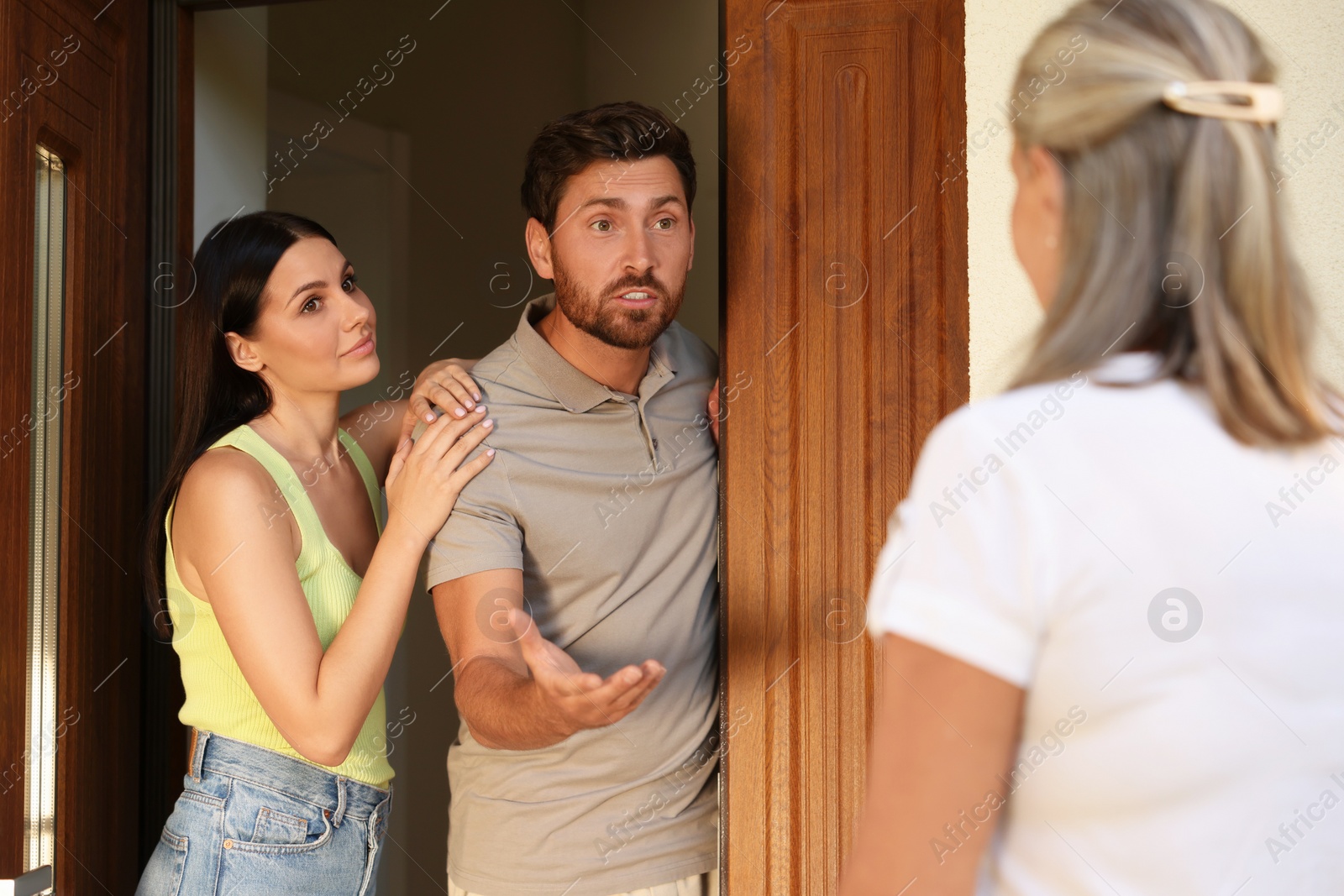 Photo of Neighbour`s quarrel. Senior woman visiting emotional young couple